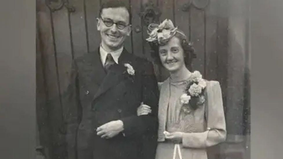 John and Blodwen Tinniswood, wearing their wedding outfits, in a black and white photo