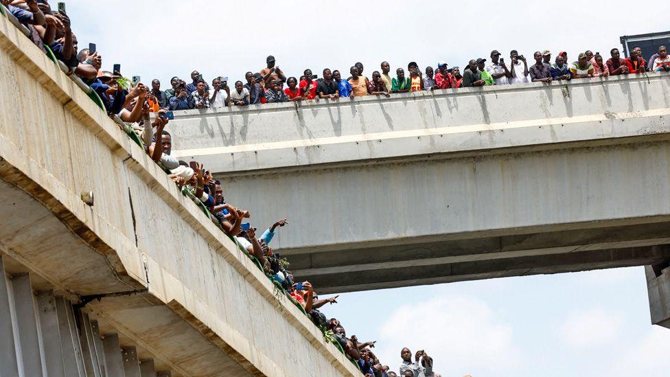 People looking over two flyovers to see the funeral cortege of Raila Odinga in Nairobi.