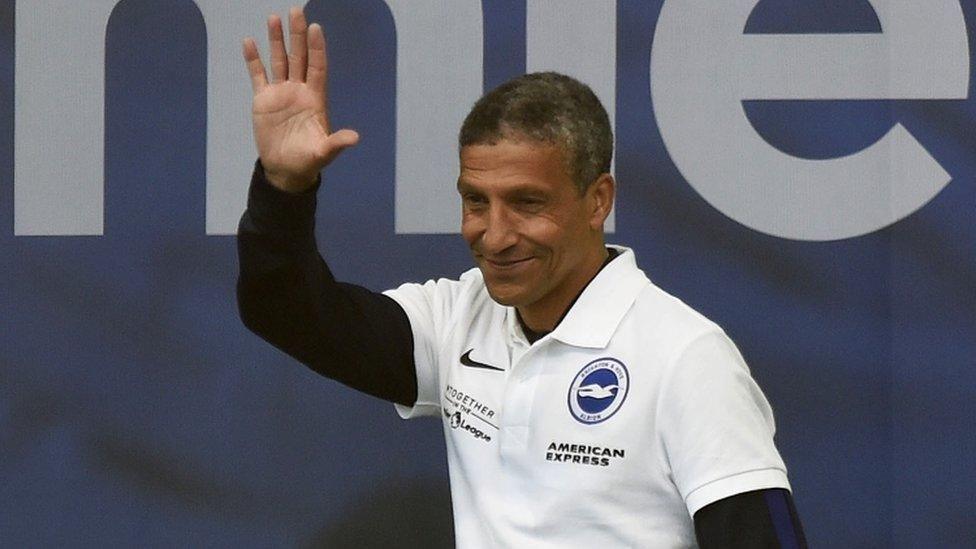 Chris Hughton wearing a white t shirt at Albion's victory parade in 2017.