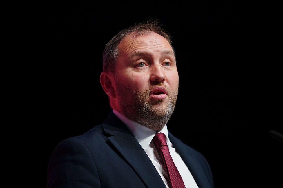 Scottish Secretary Ian Murray speaks during the Labour Party Conference. The image is cropped to show Mr Murray from the shoulders up and he speaks in front of a dark background.