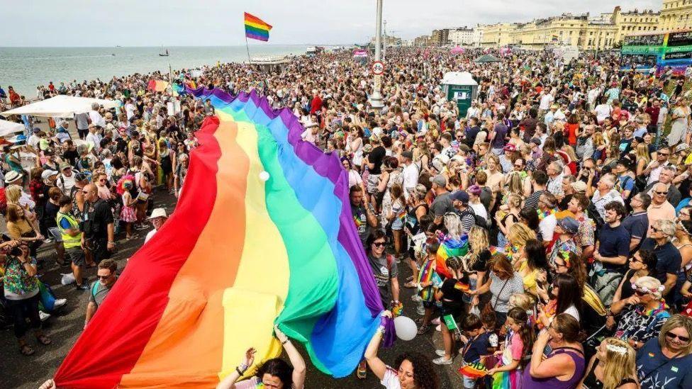 People on Brighton beach for Pride 