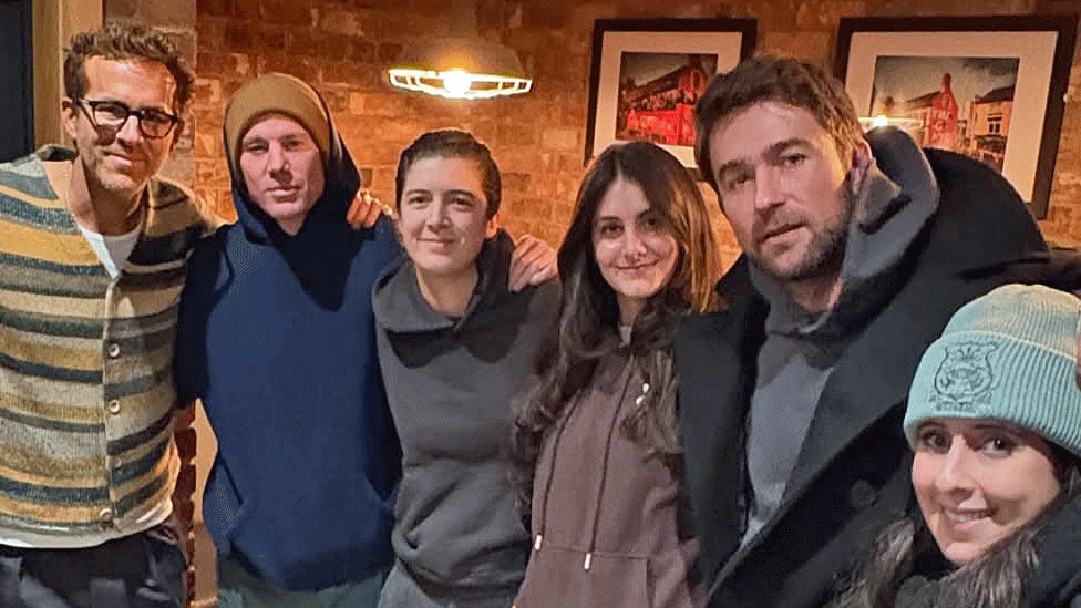 Ryan Reynolds, Channing Tatum and Brandon Sklenar pose for pictures with three other people