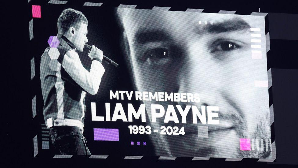 A screen with two black and white photos of Liam Payne and the words "MTV remembers Liam Payne 1993-2024"