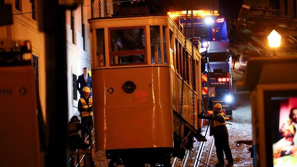 Emergency workers remove one of the funiculars, following derailment and crash of the Gloria funicular railway car