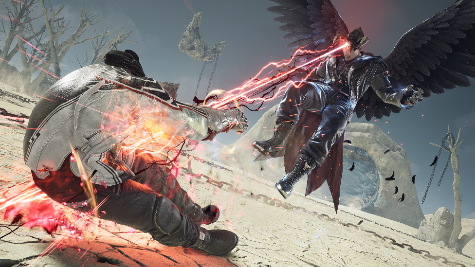 A screenshot from Tekken 8 shows Devil Jin, a demonic character with giant black wings, shooting red lasers at an opponent who is falling to the ground as the blast strikes him. They're battling in the middle of an arid desert landscape.