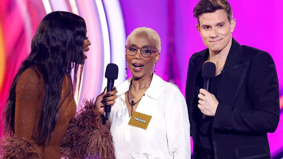 Trisha Goddard is surrounded by two presenters whilst entering the Celebrity Big Brother House on 7 April 2025