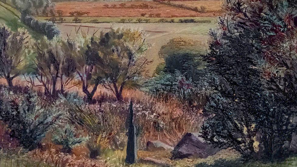 A painting by Nan Youngman of Llanfrothen in Wales. It is slightly up a hillside with dark green trees on the right, a black obelisk in the foreground, beyond it are shrubs and trees and falling away from that are fields in shades of soft green and pink. 