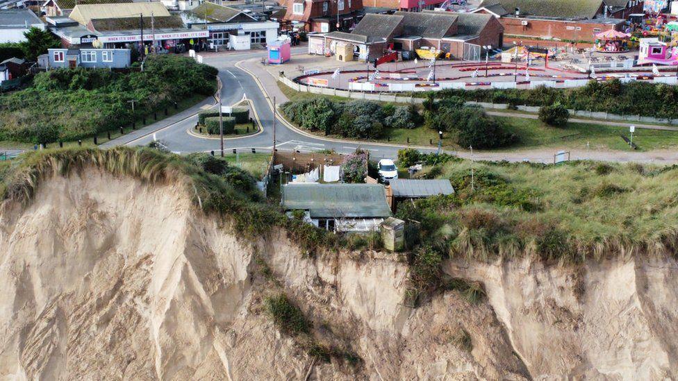 A cliff-side home at Hemsby remained close to the edge after further erosion in October following storm surges