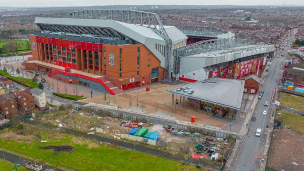 An aerial view of Liverpool FC's Anfield stadium. The area nearest the camera shows undeveloped land.