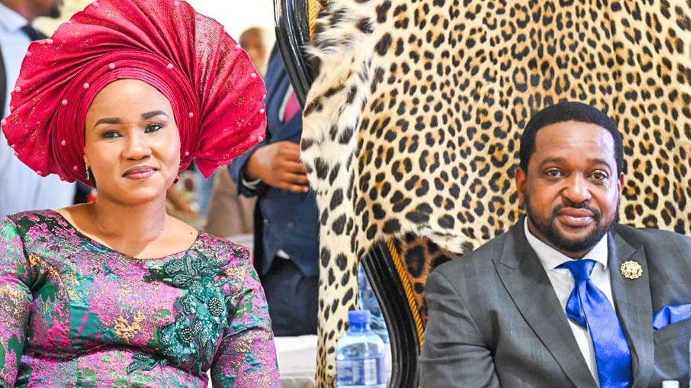 Nomzamo Myeni in a red fan headdress and embroidered dress and King Misuzulu KaZwelithini in a suit and blue tie.