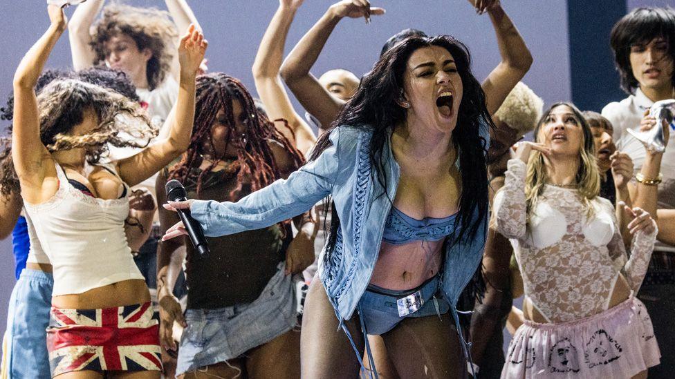 Charli XCX surrounded by dancers on stage at the Grammy Awards