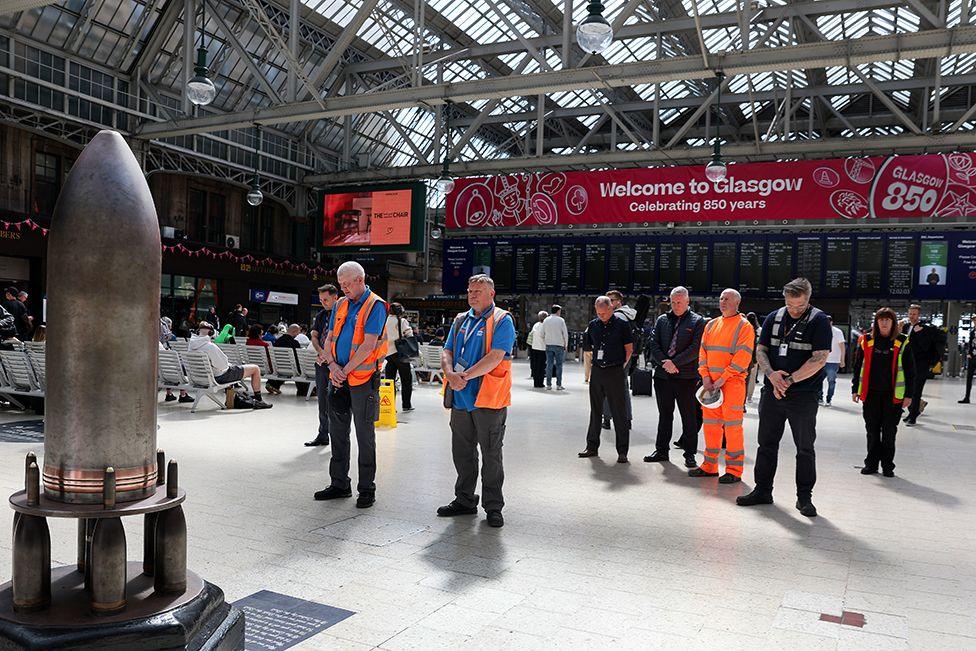 Station staff and members of the public observe a two minute silence in Central Station to mark the 80th anniversary of VE Day on May 08, 2025 in Glasgow, Scotland.