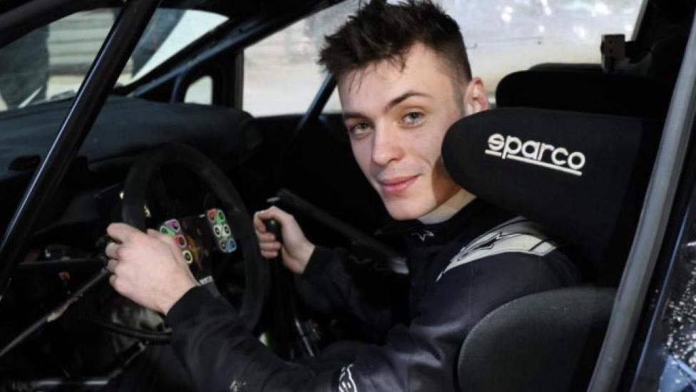 Elliot Payne sat behind the wheel of his car wearing black clothing