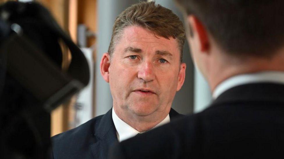 Scottish Conservative candidate Brian Whittle speaking in the lobby at Holyrood