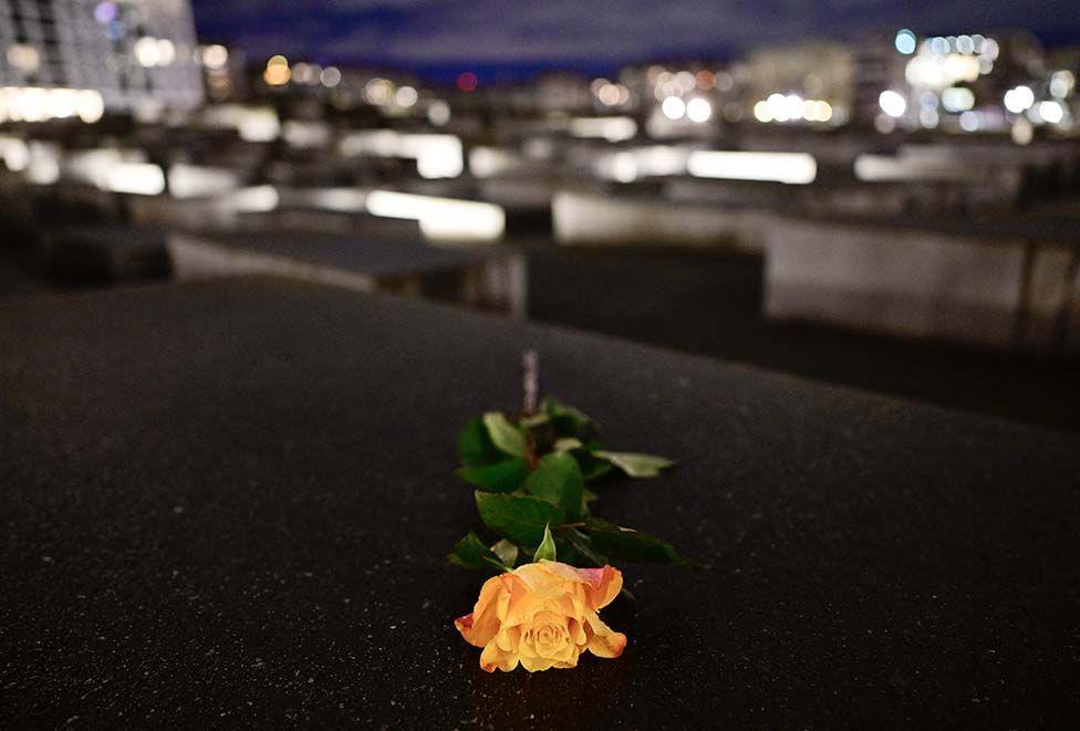 A yellow rose on a memorial stele at The Memorial to the Murdered Jews of Europe, also known as the Holocaust Memorial, in Berlin, on January 27, 2025.