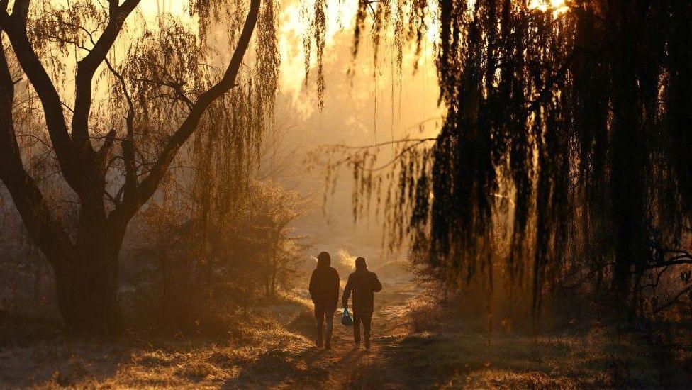 Two men take a walk on a winter in the south of Johannesburg, South Africa on 12 June.