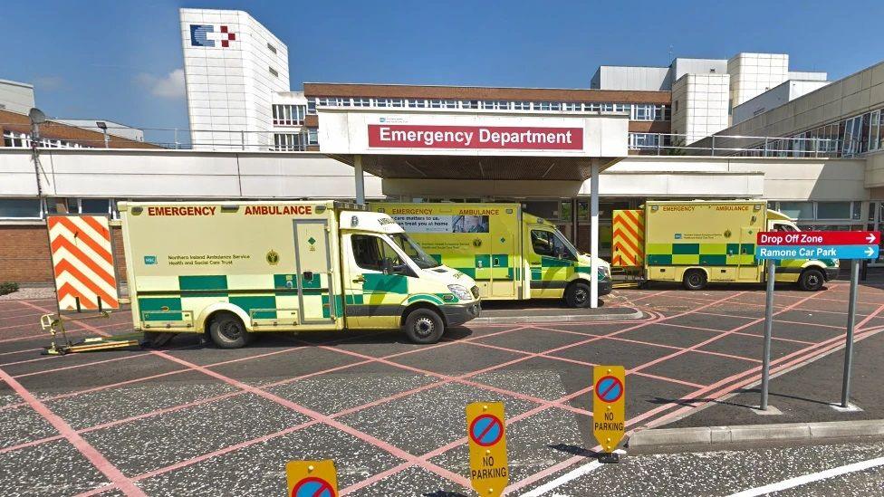 Three yellow ambulances parked outside the Craigavon hospital Emergency Department 