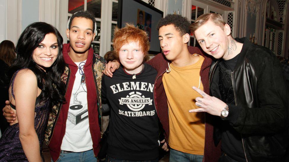 Jessie J, Harley Alexander-Sule, Ed Sheeran, Jordan Stephens and Professor Green all looking and smiling at the camera at an event.