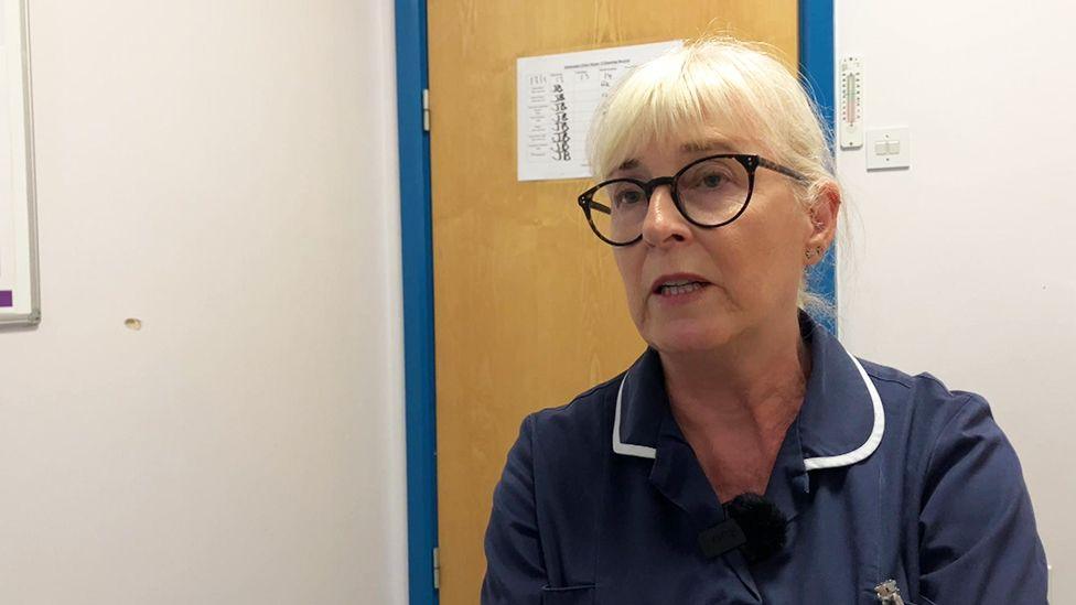 Janet Cairns, nurse clinical supervisor for the vaccination programme at Hull University Hospitals Trust, wearing glasses and a dark blue uniform