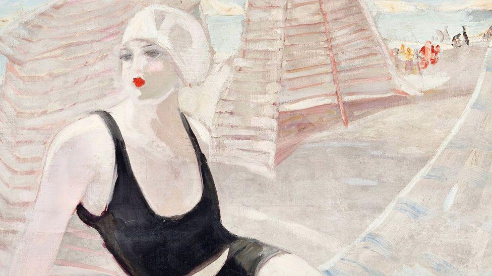 Jacqueline Marval's painting of a woman swimmer in a black costumer and white hat sitting on a beach, twisting to look over her right shoulder, 1920 to 23