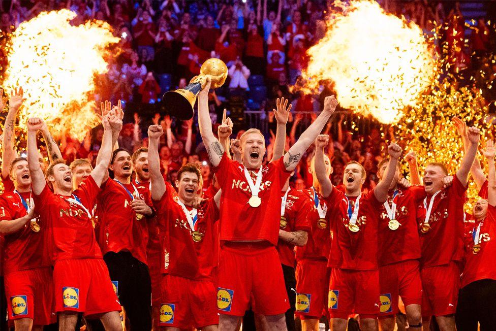 Magnus Saugstrup Jensen of Denmark lifts the IHF Men's Handball World Championship trophy at Unity Arena in Oslo, Norway