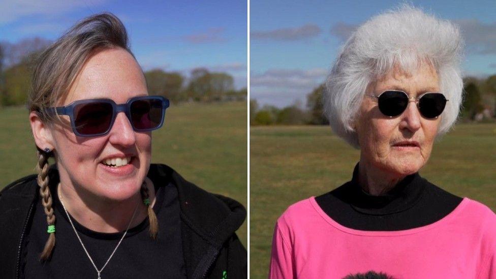 Rachel Pavet (left) wearing blue framed sunglasses and braided hair and Susan Oglesby (right) wearing a bright pink top, with black sunglasses.