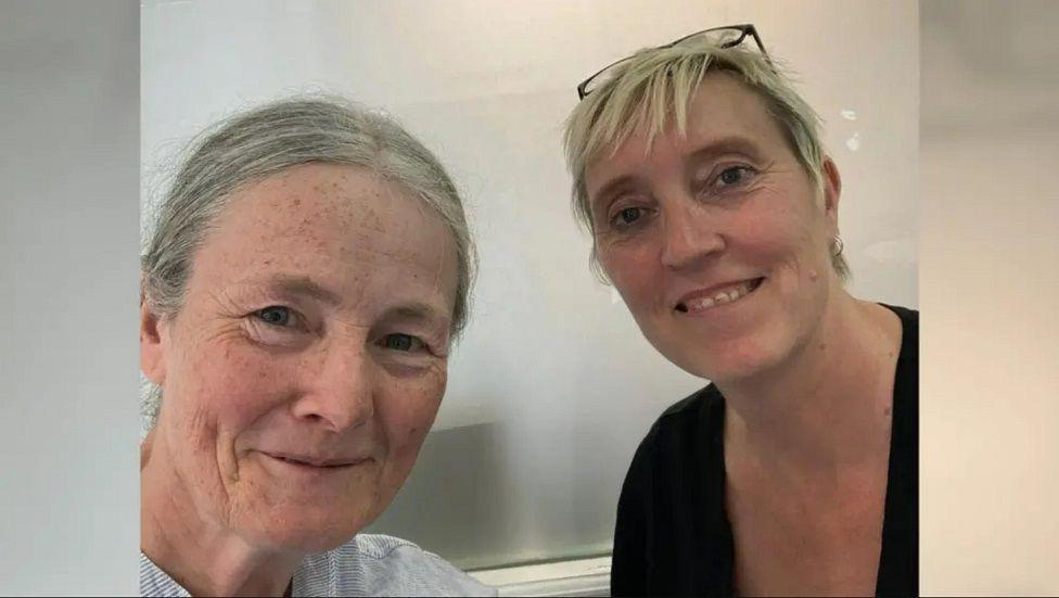 Yvonne Morley-Chisholm and Prof Caroline Wilkinson smiling at the camera in front of a grey background.