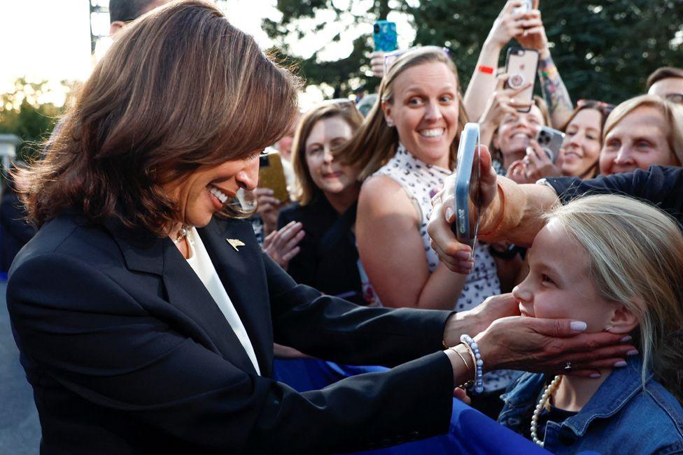 Democratic presidential nominee and US Vice President Kamala Harris greets a child during a campaign event at Ripon College in Ripon, Wisconsin, US, 3 October, 2024. 