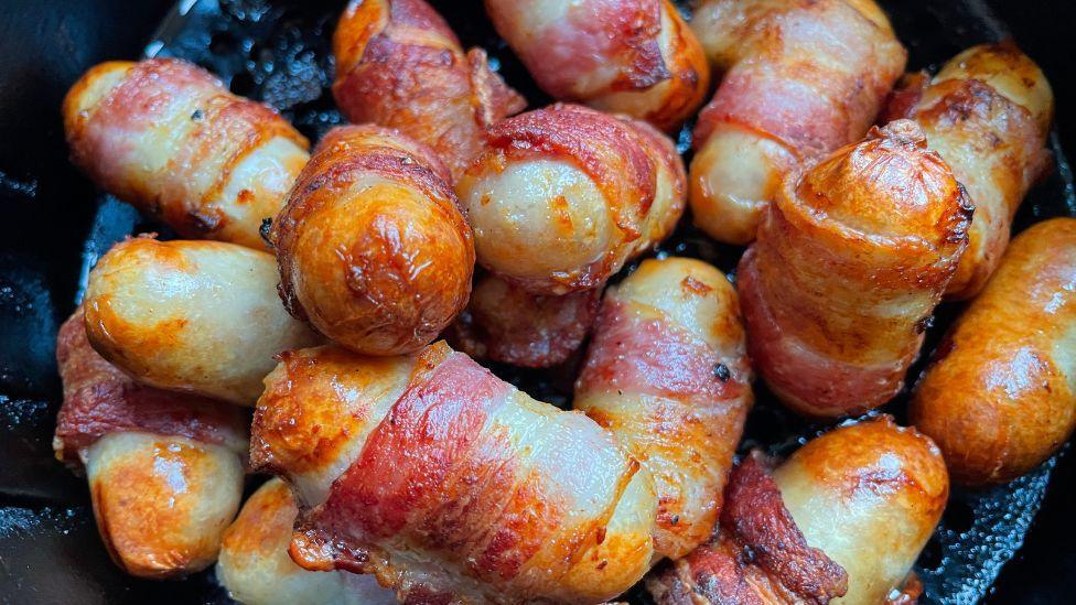 Pigs in blankets inside an air fryer. 