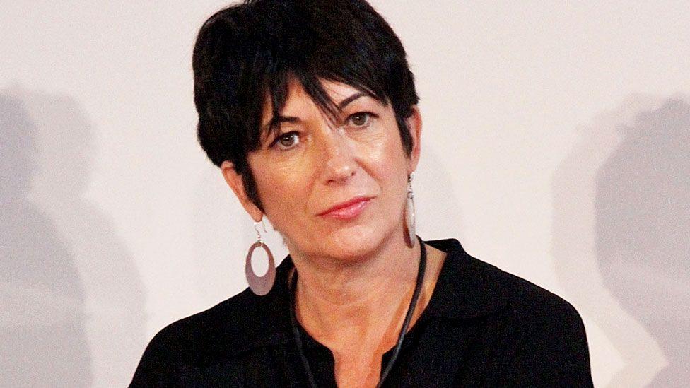 Ghislaine Maxwell looks contemplative wearing a black blouse and large earrings
