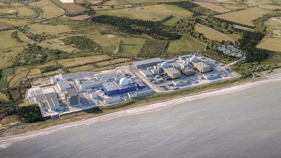 An artist's impression of Sizewell C on the Suffolk coast. The large nuclear power station is spread across a large site with numerous different buildings. Green fields have been drawn behind it while the coastline sits in front of the site.