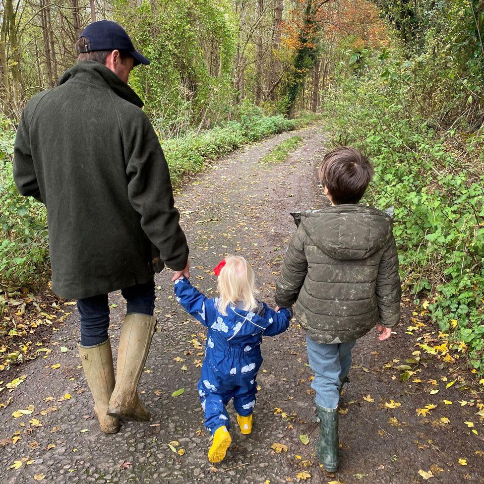 Eduardo and their two children out walking in the woods