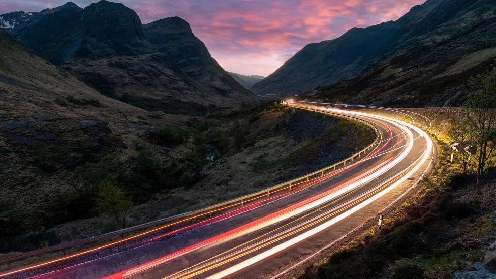 Vehicle lights on A82 through Glen Coe