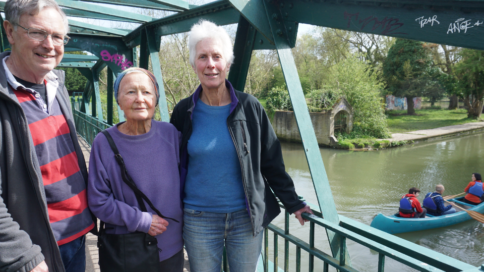 Michael Goodhart, Jean Perraton and Anne Miller standing on a bridge over the River Cam