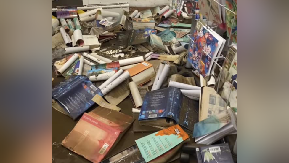 Piles of books in huge puddle of water