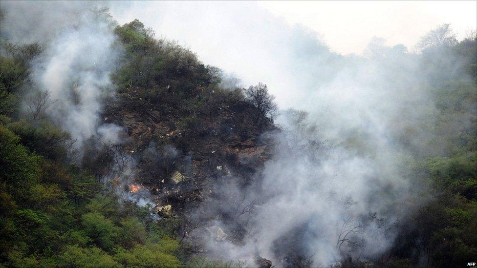 Smoke rises from the wreckage of a passenger plane in the Margalla Hills, north of Islamabad