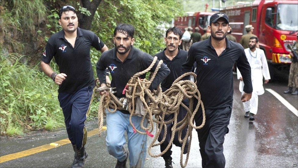 Pakistani rescue workers rush to the crash site