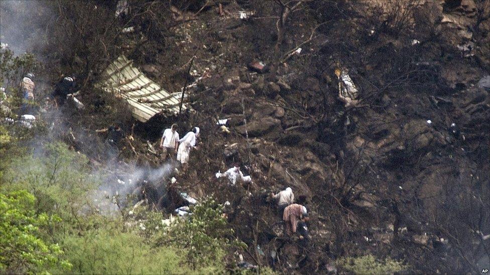 Rescue workers look for survivors at the crash site