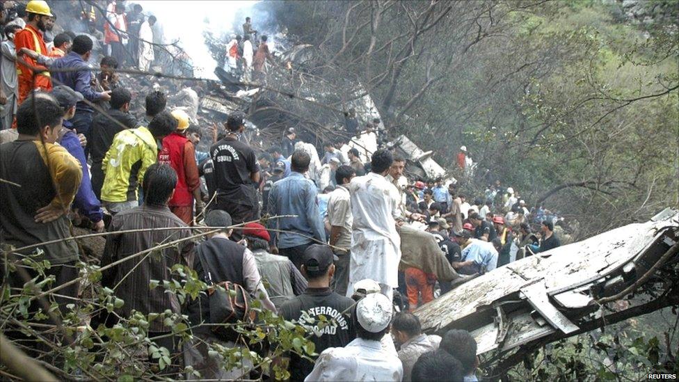 Rescuers search the crash site