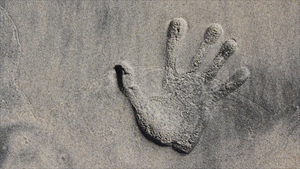 Woman's handprint on a beach in San Diego, California