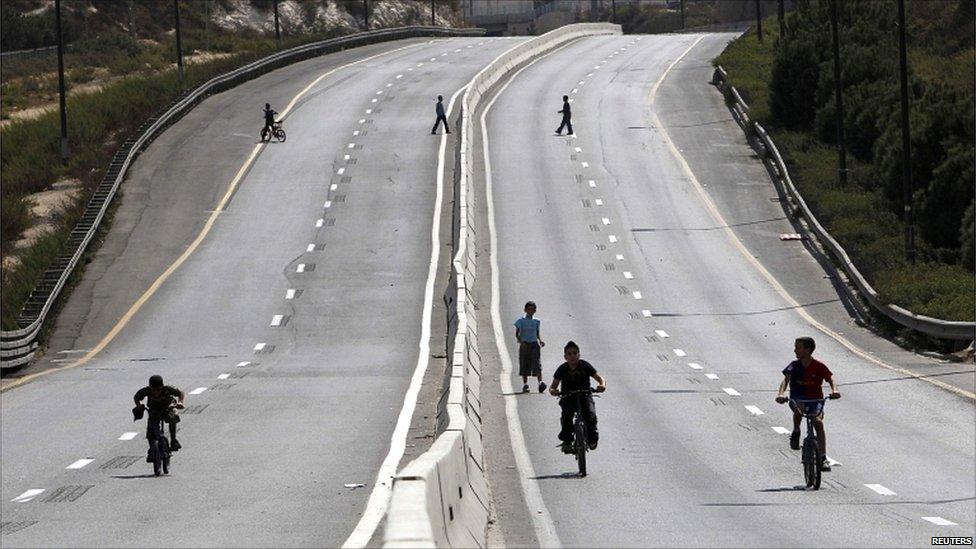 Children play on an empty road during the Jewish holiday of Yom Kippur in Jerusalem.