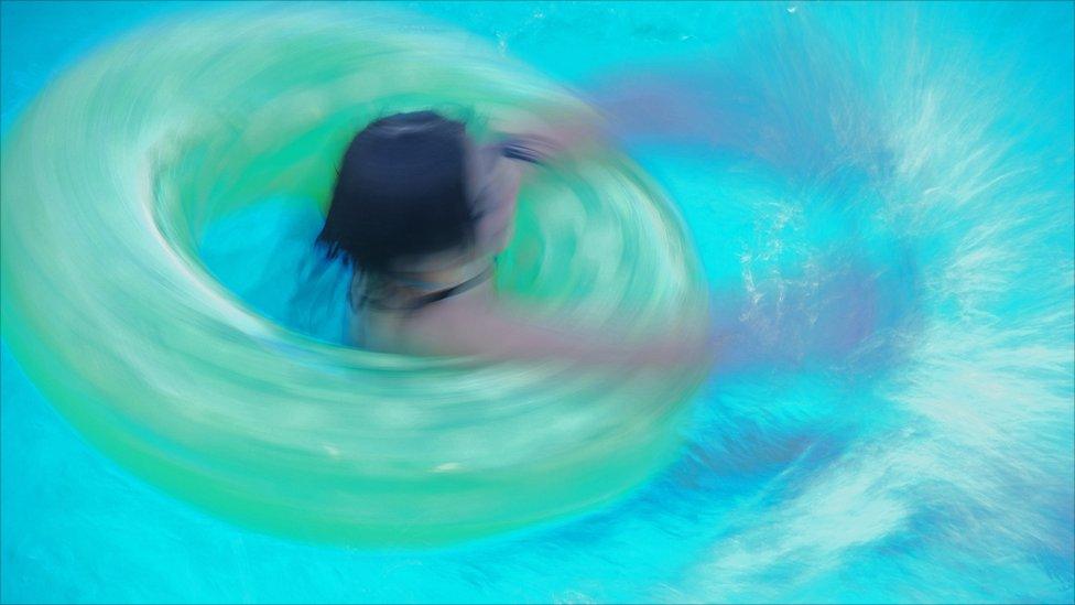 Girl playing in a swimming pool