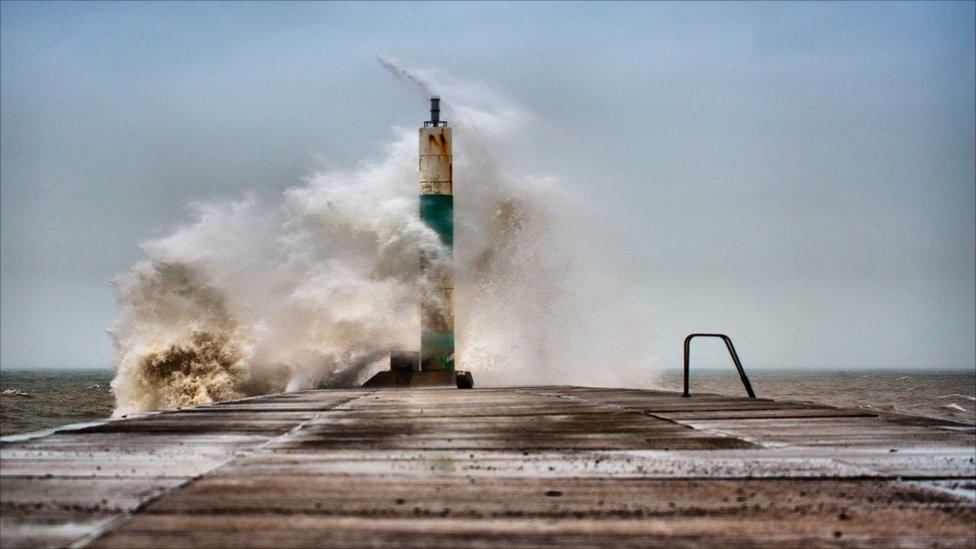 Big waves hitting a pier at Aberystwyth