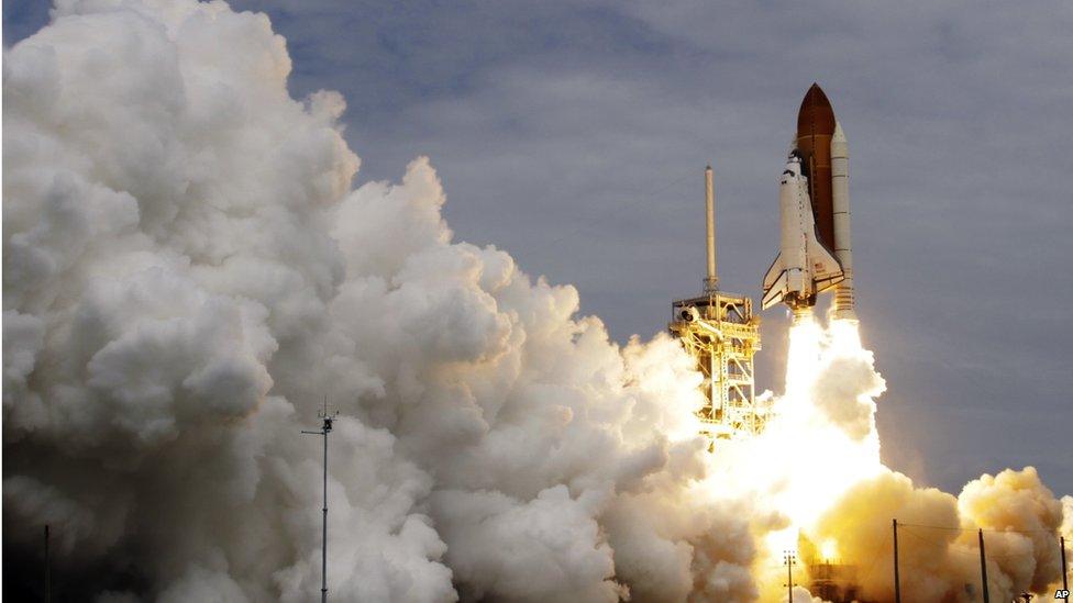 Space shuttle Atlantis lifting off on final space journey