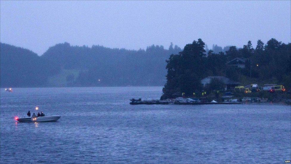 Police in boats and emergency services vehicles around Utoeya island, Norway, 22 July 2011