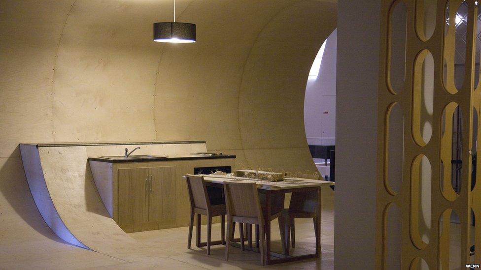 Kitchen and dining table inside the half-pipe house