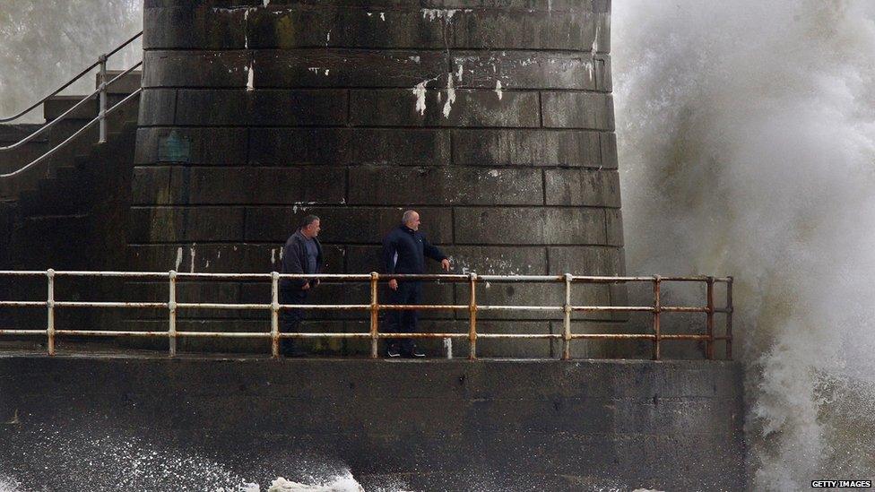 Two men are engulfed by a wave in Saltcoats on the west coast of Scotland.