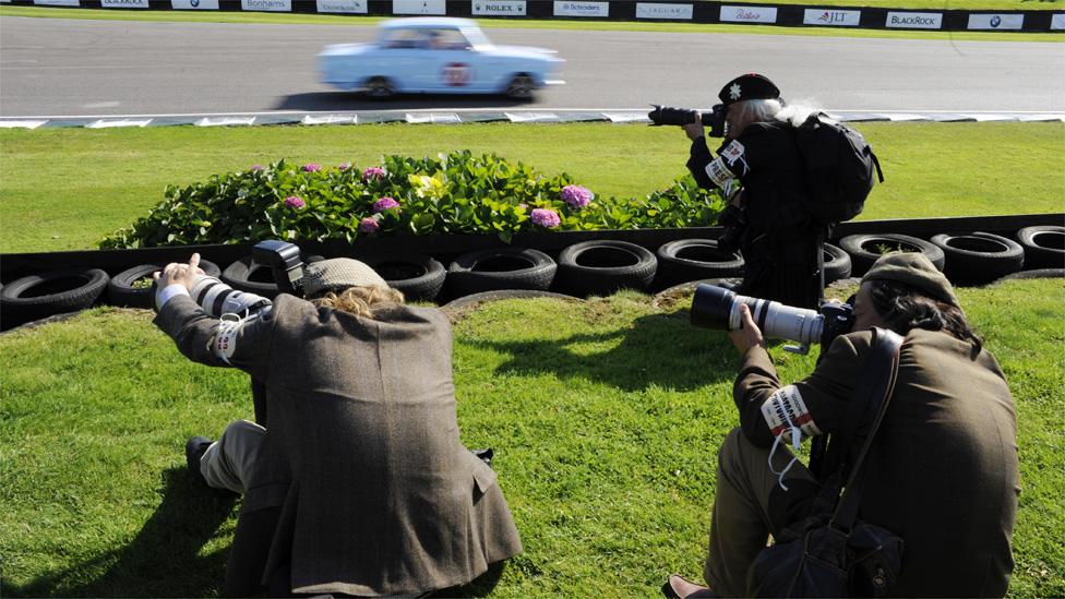 Photographers take pictures at the Goodwood Revival