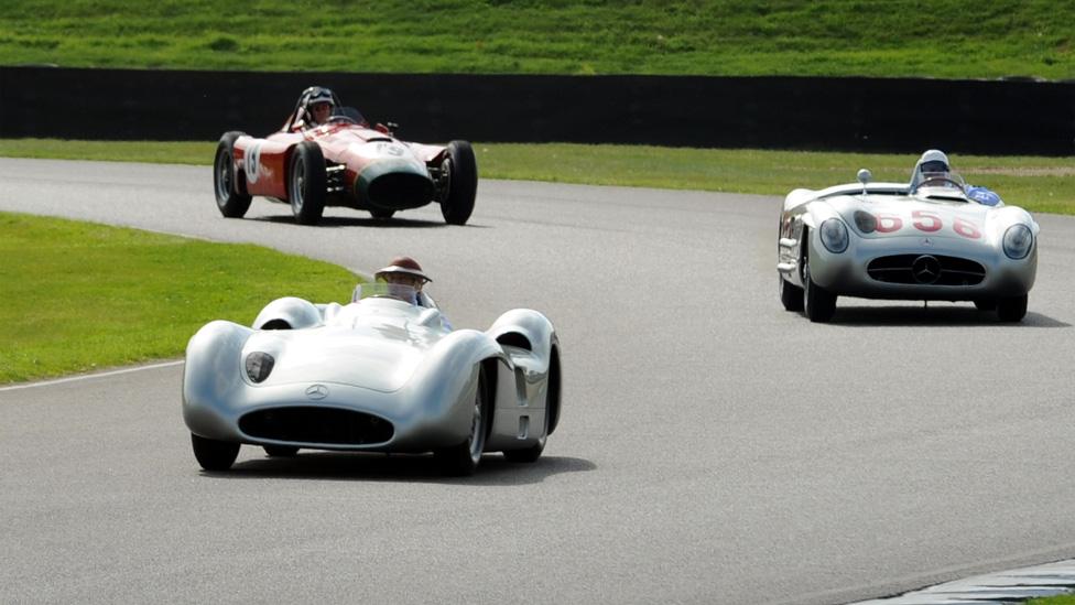 Three racing cars on the track at Goodwood