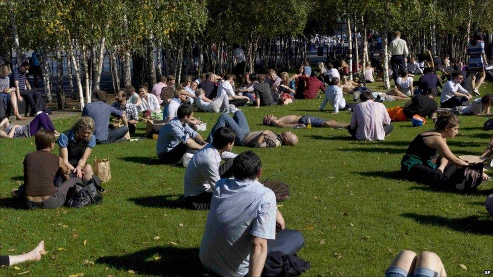 People relaxing on grass on the in London